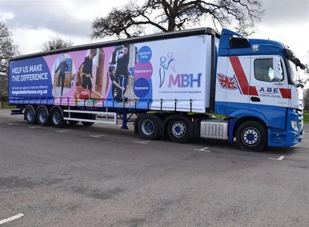 A.B.E. articulated lorry promoting MBH (a centre for movement disorders), featuring imagery and messaging about conditions like cerebral palsy, Parkinson’s, and dyspraxia, with the call to action “Help us make the difference.”