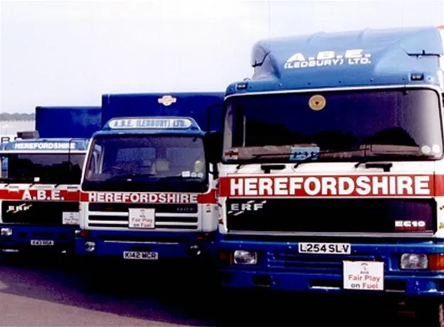 Three ABE lorries with bold ‘HEREFORDSHIRE’ branding lined up in a row, part of a vintage fleet