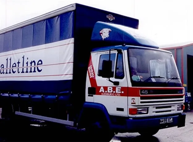 ABE Ledbury lorry with a Palletline curtain-sided trailer parked outside a depot
