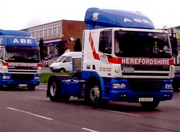 Camera crew filming a man standing beside an ABE Herefordshire truck for an interview.