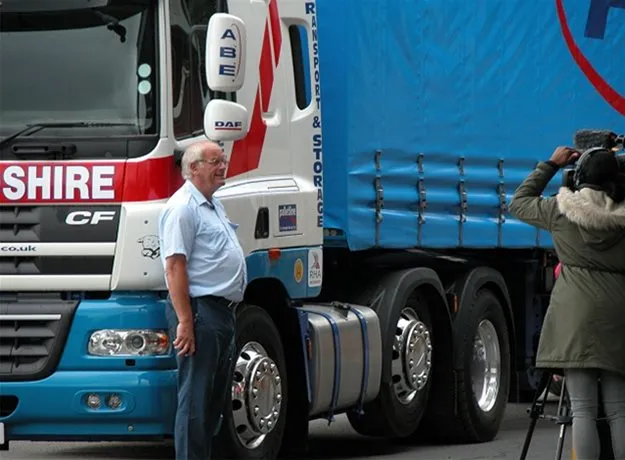 Two ABE Herefordshire lorries driving on a town street during a public event or convoy